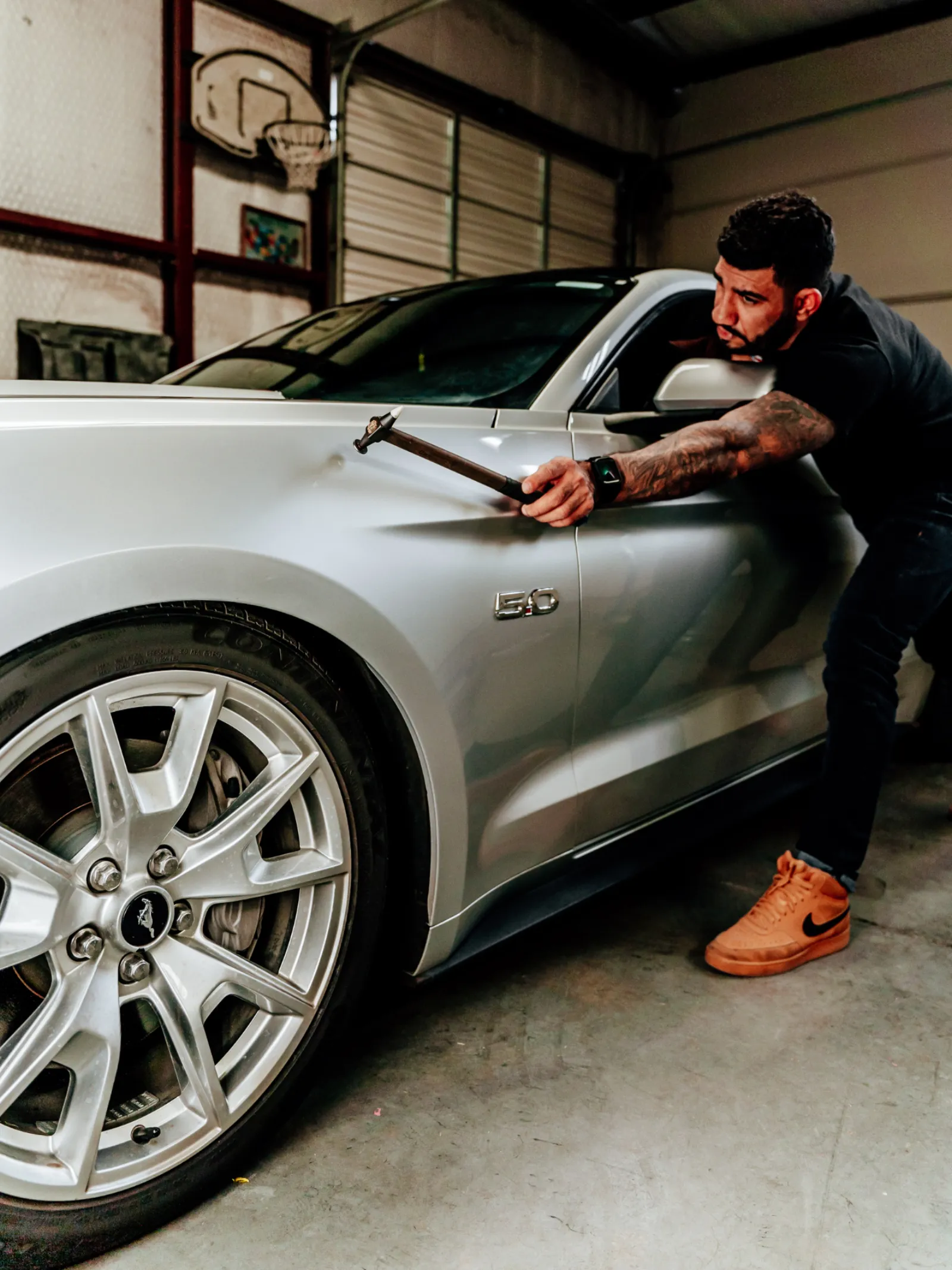 PDR technician restoring a silver Ford Mustang fender at Hail Repair Pro Lubbock TX